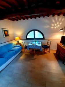 uma sala de estar com um sofá azul e uma mesa em Charming 4-Bed Cottage 15 minutes from Florence em Impruneta