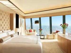 a hotel room with two beds and a large window at Fairmont Baku, Flame Towers in Baku