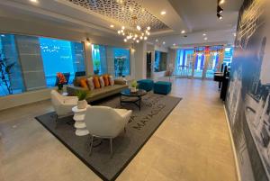 a large living room with a couch and chairs at TRYP by Wyndham Mayaguez in Mayaguez