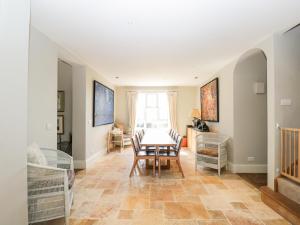 a dining room with a table and chairs at Gardeners Cottage in Hungerford