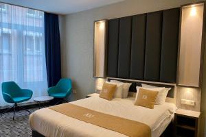 a hotel room with a bed and a large window at XO Hotels City Centre in Amsterdam