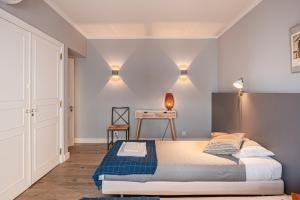 a bedroom with a bed and a desk in it at Cascais Bay Terrace ii in Cascais