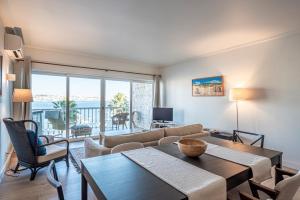 a living room with a couch and a table and chairs at Cascais Bay Terrace ii in Cascais +34 photos