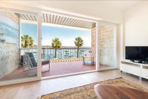 a living room with a large sliding glass door to a patio at Cascais Bay Terrace iii in Cascais