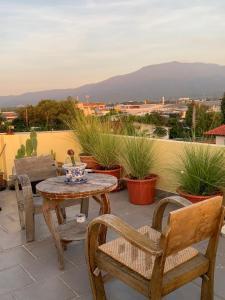 a table and chairs on a patio with a view at Gumpuju คำปู้จู้ in Chiang Mai