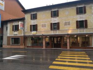 a building on a street with a crosswalk at Ristorante Stazione con alloggio in Rivera