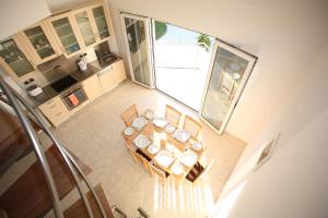 an overhead view of a kitchen with a table and chairs at Villa Constance, Grapevines Villas in Makry Gialos