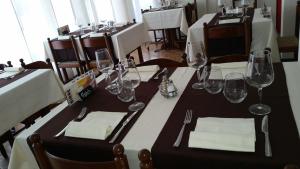 a table with wine glasses and napkins on it at Ristorante Stazione con alloggio in Rivera