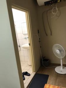 a bathroom with a shower and a sink and a fan at Together Stay in Juguang