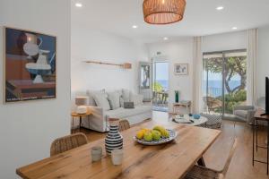 a living room with a table with a bowl of fruit on it at Lazareto Mar by An Island Apart in Funchal +41 photos