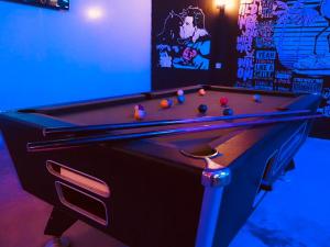 a pool table with balls on it in a room at Wild Ones Hostel in Bangkok