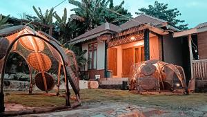 a house with two gates in front of it at Lontart Guesthouse in Nggorang