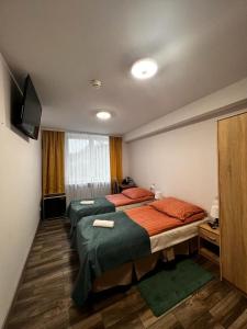 a room with two beds and a television in it at Selment Resort in Ełk
