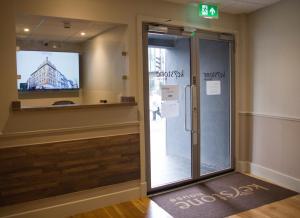 a sliding glass door in a room with a television at Keystone House in London