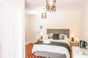 a bedroom with a bed and a chandelier at The Brown Horse Hotel in Wolsingham