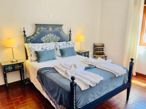une chambre avec un lit avec des serviettes dessus dans l'établissement Casa dos Trevos, 5 Bedroom Villa with Pool, à Lagos