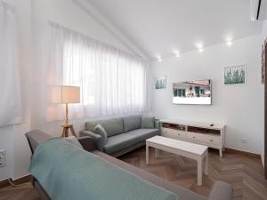 a living room with a couch and a table at La Isla , tu hogar en Torre del Mar. in Torre del Mar