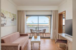 a living room with a couch and a table at Iberostar Selection Andalucia Playa in Chiclana de la Frontera