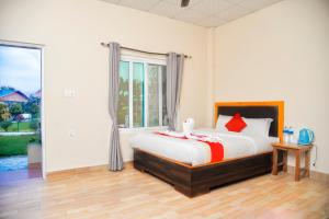 a bedroom with a bed and a large window at Hotel Greenland Safari in Sauraha