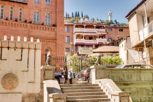 a group of stairs in a city with buildings at Sina Hotel in Tbilisi City