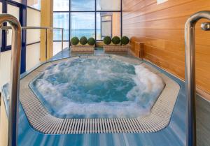a jacuzzi tub in a room with clouds at Hotel Yaramar - Adults Recommended in Fuengirola
