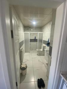 a white bathroom with a toilet and a sink at homeland residans in Tokat