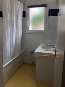 a bathroom with a sink and a window at House near the ocean and forest in Soulac-sur-Mer