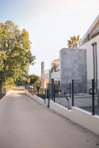 a street with a fence and a building at T3 30 dans résidence neuve près des plages in Saint-Cyr-sur-Mer