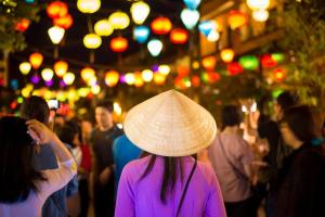 a woman wearing a hat walking through a crowd of people at Two-Bedrooms - POOL SEA VIEW - 6A - BLUE SEA APARTMENT in Da Nang +34 photos