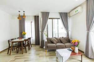 a living room with a couch and a table at Two-Bedrooms - POOL SEA VIEW - 6A - BLUE SEA APARTMENT in Da Nang