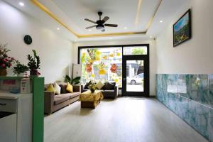 a living room with a couch and a ceiling fan at Two-Bedrooms - POOL SEA VIEW - 6A - BLUE SEA APARTMENT in Da Nang