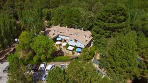 an aerial view of a house with cars parked in the forest at Kampaoh Cazorla in El Valle