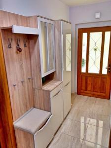 a kitchen with a cabinet and a door with a window at Apartman Podgora with beautiful sea view in Podgora