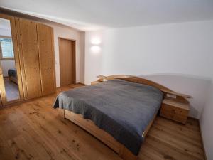 a bedroom with a large wooden bed in a room at Burtscherhof in Braz in Ausserbraz