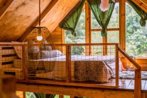 a bed with a bird cage on top of it at Banana Farm Eco Hostel in Arusha
