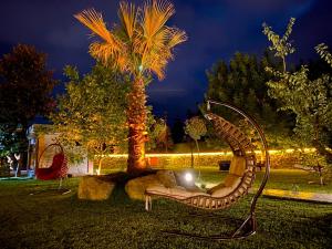 a metal sculpture of a couch in front of a palm tree at ZK Wooden Village in Sapanca