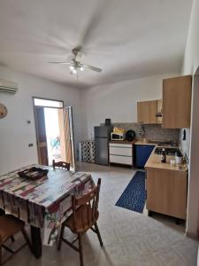 a kitchen and dining room with a table and chairs at Casa Vacanze - Da Peppina in Petrosino +19 photos