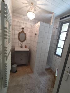 a bathroom with a sink and a mirror at Les Houstalous in Lacombe +12 photos
