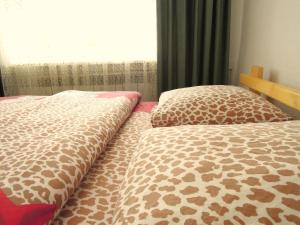 two beds sitting next to each other in a bedroom at Arthouse in Karakol