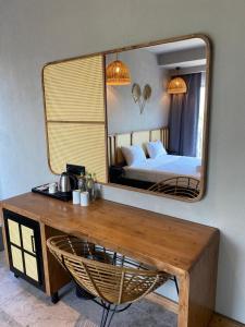a bedroom with a mirror and a table and a bed at Icon Beach Suites Hotel Sovalye Island in Fethiye