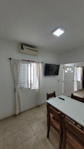 a living room with a table and a window at Departamento Don Nico in San José de la Dormida