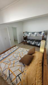a bedroom with a large bed in a room at Departamento Don Nico in San José de la Dormida