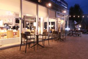 a group of tables and chairs in front of a store at Hotel Galion in Gdańsk
