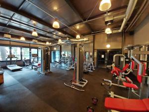 a gym with a lot of equipment in a room at Hotel Galion in Gdańsk