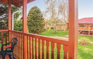 a screened in porch with a bench and a playground at Amazing Home In Ustronie Morskie With 1 Bedrooms And Wifi in Ustronie Morskie