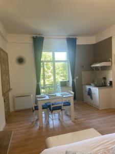 a kitchen and dining room with a table and chairs at Studio Zen in Boulogne-sur-Mer