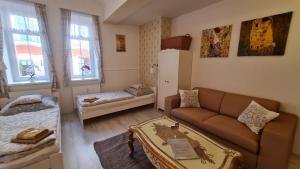 a living room with a couch and a bed at Studio near Congress Centre II. in Prague