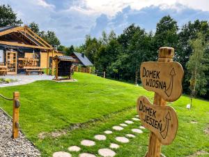 a sign in a yard with a wooden house at Leśne Zacisze Iwkowa in Iwkowa