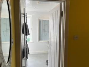 a bathroom with yellow walls and a mirror at St John's Town of Dalry Glentress Apartment 1 in Dalry