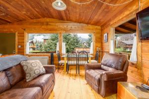 ein Wohnzimmer mit einem Sofa, Stühlen und einem Tisch in der Unterkunft Alpina Cabin in Girdwood